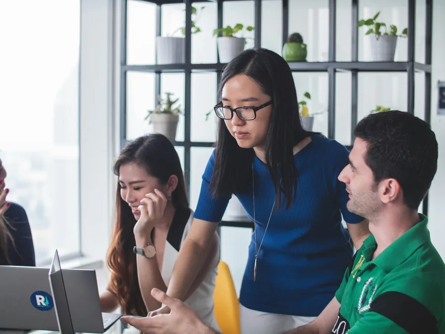 A small team planning content together at a laptop